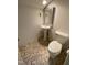 Small bathroom with pedestal sink, toilet and tile floor at 446 Crossvine Close, Pittsboro, NC 27312