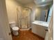Bathroom includes a toilet, corner shower, and vanity at 446 Crossvine Close, Pittsboro, NC 27312