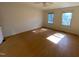 Bright bedroom with hardwood floors and two windows at 446 Crossvine Close, Pittsboro, NC 27312