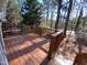 Wooden deck surrounded by mature trees offers private outdoor enjoyment at 446 Crossvine Close, Pittsboro, NC 27312