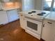 Kitchen featuring white appliances and an island cooktop at 446 Crossvine Close, Pittsboro, NC 27312