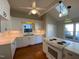 Spacious kitchen with white cabinets, hardwood floors, and island at 446 Crossvine Close, Pittsboro, NC 27312