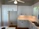 White kitchen with ample cabinet space and hardwood floors at 446 Crossvine Close, Pittsboro, NC 27312