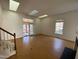 Bright living room featuring skylights, hardwood floors, fireplace, and access to sunroom at 446 Crossvine Close, Pittsboro, NC 27312