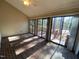 Enclosed sunroom with brick floor and large windows leading to a deck at 446 Crossvine Close, Pittsboro, NC 27312