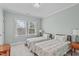 Charming bedroom with two twin-size beds and plenty of natural light at 547 Glenville Lake Dr, Fuquay Varina, NC 27526