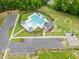 Aerial view showcasing the community pool, bathhouse, playground and parking area at 59 Pretty Run Branch Ln, Wendell, NC 27591