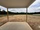 Covered patio with a view of the private backyard and lush greenery at 59 Pretty Run Branch Ln, Wendell, NC 27591