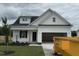 New construction home with white siding, attached garage, and newly seeded front yard at 59 Pretty Run Branch Ln, Wendell, NC 27591