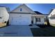 Craftsman style home with white siding, two-car garage, and landscaping at 59 Pretty Run Branch Ln, Wendell, NC 27591
