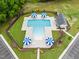 Aerial view of a community swimming pool area featuring lounge chairs and umbrellas at 59 Pretty Run Branch Ln, Wendell, NC 27591