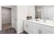 Bathroom with double vanity, white cabinets, and walk-in shower at 6020 Sodium St, Raleigh, NC 27610