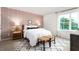 Bright bedroom with a queen bed, patterned rug, and window at 6020 Sodium St, Raleigh, NC 27610