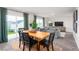 Dining area with wood table, gray chairs, and view to living room at 6020 Sodium St, Raleigh, NC 27610