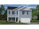 Two-story house with blue siding, white garage door, and landscaping at 6020 Sodium St, Raleigh, NC 27610