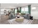 Open living space with gray sectional sofa and kitchen view at 6020 Sodium St, Raleigh, NC 27610