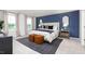 Main bedroom with king bed, blue accent wall, and two nightstands at 6020 Sodium St, Raleigh, NC 27610