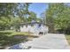 White brick ranch house with new deck and driveway at 713 Hudson Ave, Durham, NC 27704