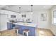 Modern kitchen with white and blue cabinets and an island at 713 Hudson Ave, Durham, NC 27704