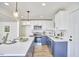 Modern kitchen with white and blue cabinets and an island at 713 Hudson Ave, Durham, NC 27704