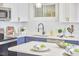 Modern kitchen sink and cabinets with white quartz countertops at 713 Hudson Ave, Durham, NC 27704