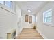 Laundry room with white brick and wood-look flooring at 713 Hudson Ave, Durham, NC 27704
