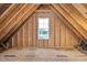 Unfinished attic space with wood framing and a single window at 7723 Barefoot Rd, Fuquay Varina, NC 27526