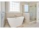 Spa-like bathroom featuring a freestanding tub and a large shower at 7723 Barefoot Rd, Fuquay Varina, NC 27526