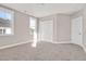 Bright bedroom with carpet, double doors, and large windows at 7723 Barefoot Rd, Fuquay Varina, NC 27526