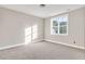 Spacious bedroom with carpeted floor and large window at 7723 Barefoot Rd, Fuquay Varina, NC 27526