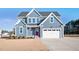 Two-story home with gray siding, red door, and a white garage at 7723 Barefoot Rd, Fuquay Varina, NC 27526