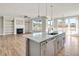 Open concept kitchen with gray island and hardwood floors at 7723 Barefoot Rd, Fuquay Varina, NC 27526