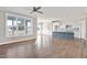 Open concept kitchen with gray island, white cabinets, and stainless steel appliances at 7723 Barefoot Rd, Fuquay Varina, NC 27526
