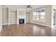 Spacious living room with hardwood floors, built-in shelving, and a fireplace at 7723 Barefoot Rd, Fuquay Varina, NC 27526