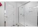 Modern bathroom featuring a glass-enclosed shower with white subway tile and decorative floor tiles at 930 Allen Pk Dr, Raleigh, NC 27604