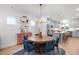 Bright dining area with a round table, stylish blue chairs, and a view of the modern kitchen at 930 Allen Pk Dr, Raleigh, NC 27604