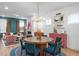 Stylish dining area with a round table, blue chairs, and an open view to the living room at 930 Allen Pk Dr, Raleigh, NC 27604