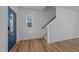 Bright entryway featuring wood floors, a staircase, and a blue front door with glass panels at 930 Allen Pk Dr, Raleigh, NC 27604