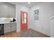 Mudroom area features a pink door, modern gray cabinets, and a convenient space with natural light at 930 Allen Pk Dr, Raleigh, NC 27604