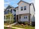 Stylish two-story home with white siding, a cozy front porch, and beautifully landscaped front yard at 930 Allen Pk Dr, Raleigh, NC 27604