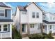 Charming two-story home with white and gray exterior and a welcoming front porch with brick pillars at 930 Allen Pk Dr, Raleigh, NC 27604
