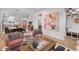Open-concept living space with pink chairs, stylish art, and views into the dining and kitchen areas at 930 Allen Pk Dr, Raleigh, NC 27604