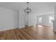 Open living area with wood-look floors, modern lighting, and bright white walls, creating a spacious feel at 930 Allen Pk Dr, Raleigh, NC 27604