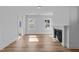 Bright living room with wood-look floors, a modern fireplace, and large windows providing ample natural light at 930 Allen Pk Dr, Raleigh, NC 27604