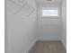This is a walk-in closet with wire shelving and a window at 930 Allen Pk Dr, Raleigh, NC 27604