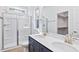 Bathroom features a double sink vanity with a tiled shower and a sliding glass door at 0 Cedar Grove Church Rd Rd, Roxboro, NC 27574