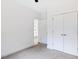 Bright bedroom with neutral carpet, white walls and closet; view to sunny room with hardwood floors at 0 Cedar Grove Church Rd Rd, Roxboro, NC 27574