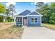 Charming home with blue siding, white trim, pink front door, and a concrete driveway at 0 Cedar Grove Church Rd Rd, Roxboro, NC 27574