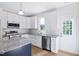 Modern kitchen features stainless appliances, granite counters, and white cabinetry at 0 Cedar Grove Church Rd Rd, Roxboro, NC 27574
