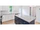 Close-up of kitchen island featuring white cabinets, granite countertops and stainless appliances at 0 Cedar Grove Church Rd Rd, Roxboro, NC 27574